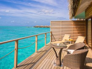 Brown Wicker Chairs and Table Beside Body of Water