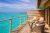 Brown Wicker Chairs and Table Beside Body of Water